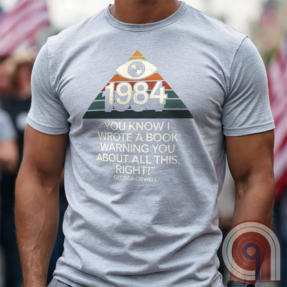 Big Brother Is All Seeing. This Orwellian dystopia shirt captures the chilling reality of mass surveillance, censorship, and authoritarian thought control. Designed for those who reject propaganda and resist digital tyranny, this bold graphic tee is a must-have for defenders of free speech. Every camera, every data log, every restriction—the system grows stronger. Stay vigilant, speak truth, and never submit to those who erase history to control the future. The fight for truth is far from over! Color: Ash