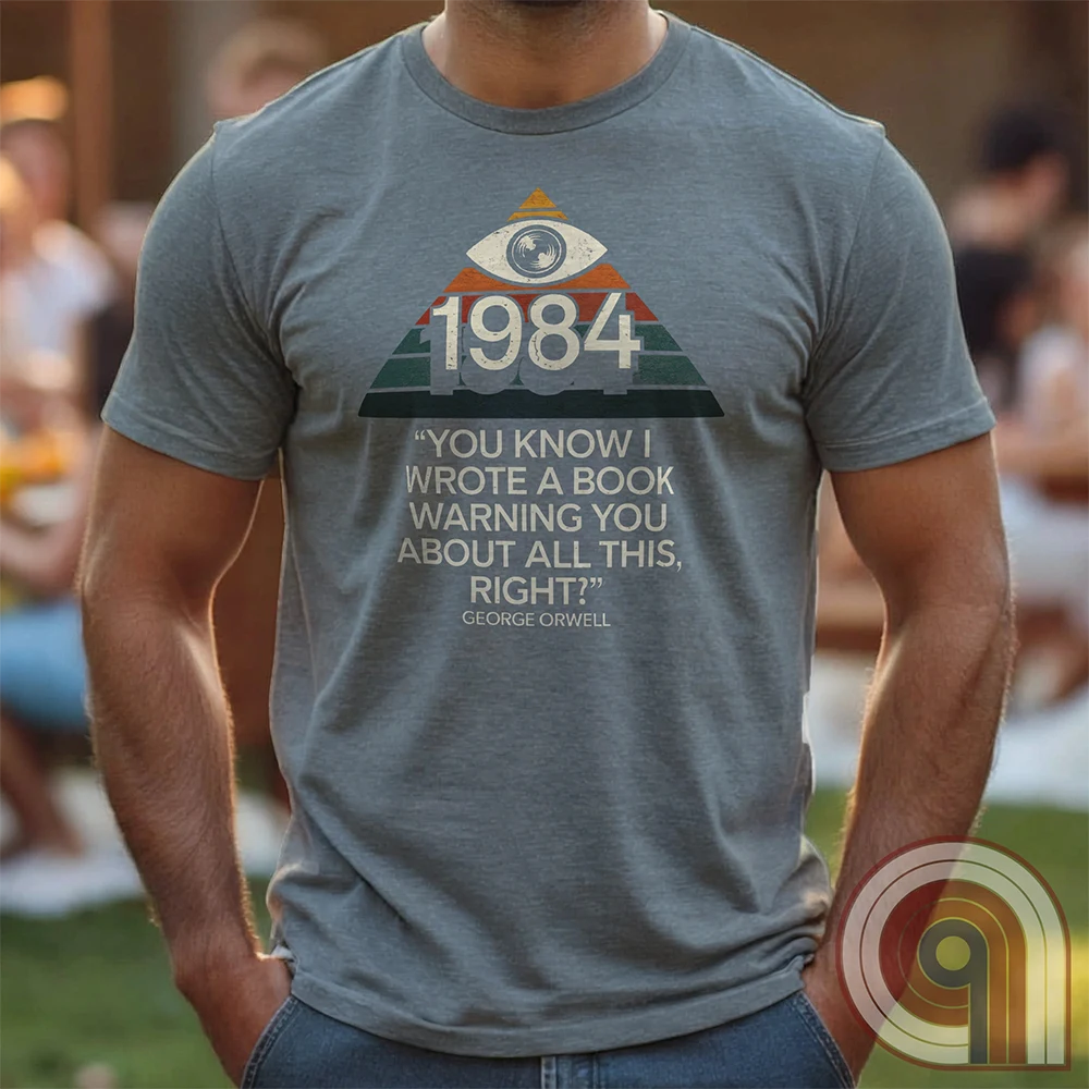 Big Brother Is All Seeing. This Orwellian dystopia shirt captures the chilling reality of mass surveillance, censorship, and authoritarian thought control. Designed for those who reject propaganda and resist digital tyranny, this bold graphic tee is a must-have for defenders of free speech. Every camera, every data log, every restriction—the system grows stronger. Stay vigilant, speak truth, and never submit to those who erase history to control the future. The fight for truth is far from over! Color: Grey