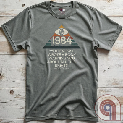 Big Brother Is All Seeing. This Orwellian dystopia shirt captures the chilling reality of mass surveillance, censorship, and authoritarian thought control. Designed for those who reject propaganda and resist digital tyranny, this bold graphic tee is a must-have for defenders of free speech. Every camera, every data log, every restriction—the system grows stronger. Stay vigilant, speak truth, and never submit to those who erase history to control the future. The fight for truth is far from over! Color: Grey