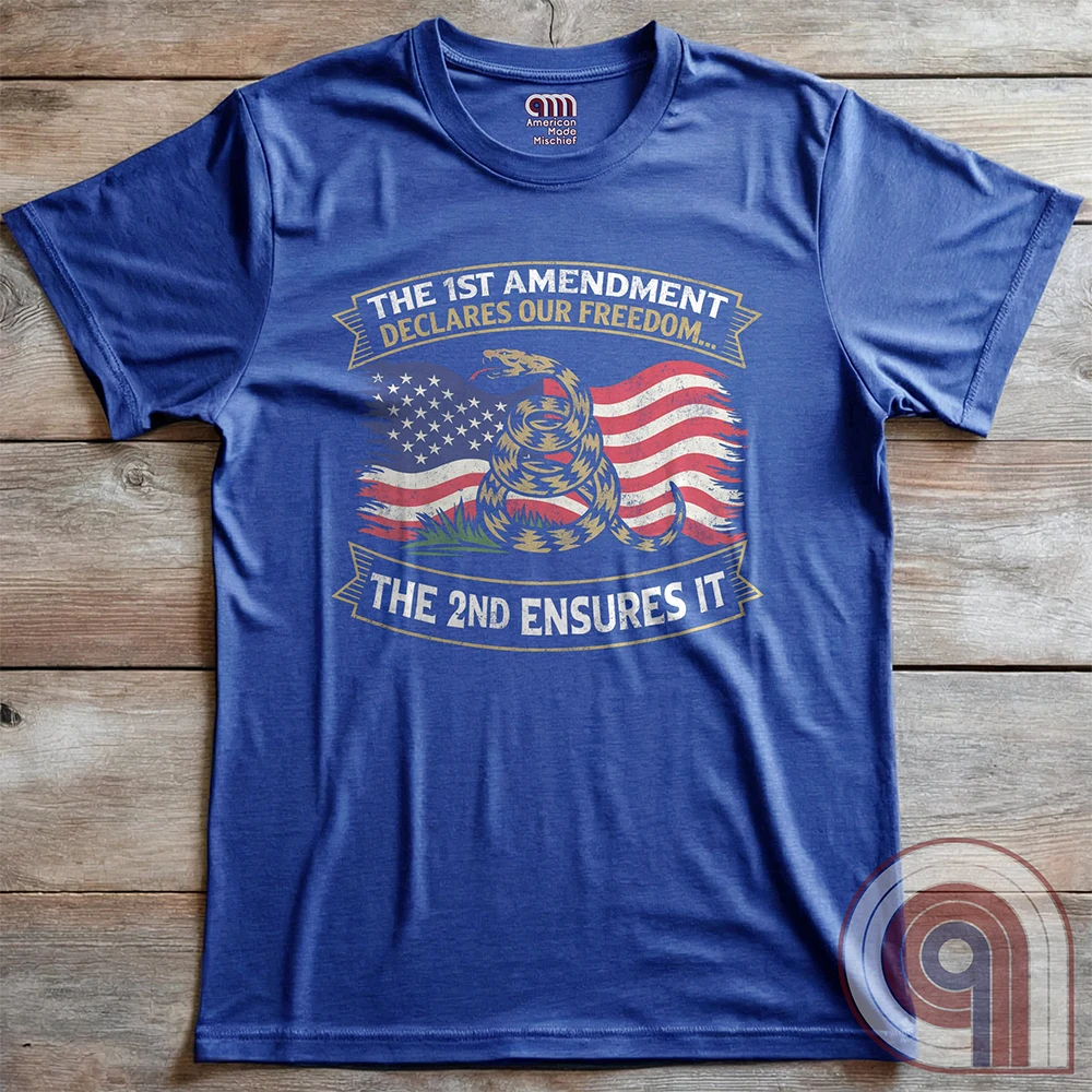 Stand for free speech and gun rights with this bold 1st & 2nd Amendment t-shirt. A distressed American flag with a coiled Gadsden snake, symbolizing freedom and resistance. ‘The 1st Amendment Declares Our Freedom… The 2nd Ensures It’ highlights the vital connection between free speech and the right to bear arms. A powerful design for gun rights advocates, patriots, and defenders of liberty who believe in self-defense, constitutional rights, and protecting American independence from tyranny. Color:  Blue