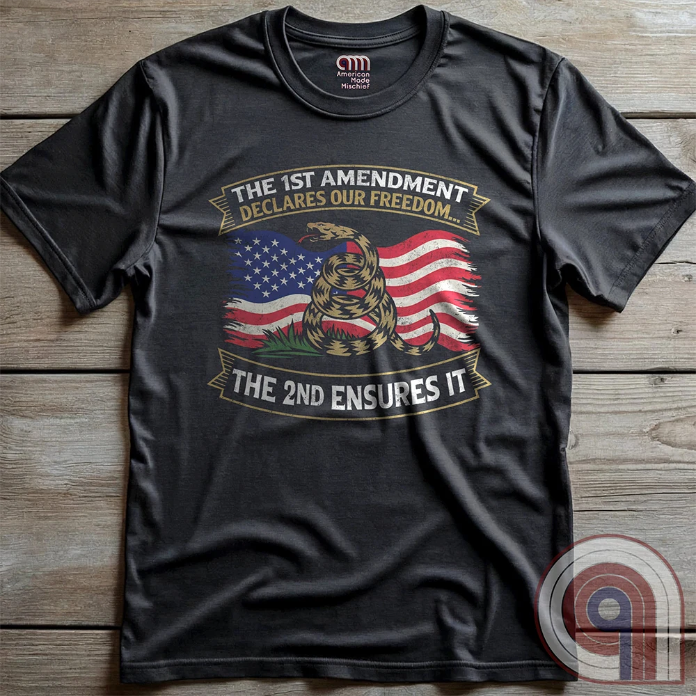 Stand for free speech and gun rights with this bold 1st & 2nd Amendment t-shirt. A distressed American flag with a coiled Gadsden snake, symbolizing freedom and resistance. ‘The 1st Amendment Declares Our Freedom… The 2nd Ensures It’ highlights the vital connection between free speech and the right to bear arms. A powerful design for gun rights advocates, patriots, and defenders of liberty who believe in self-defense, constitutional rights, and protecting American independence from tyranny. Color: Charc