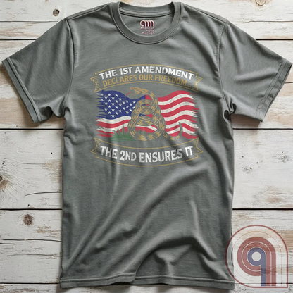 Stand for free speech and gun rights with this bold 1st & 2nd Amendment t-shirt. A distressed American flag with a coiled Gadsden snake, symbolizing freedom and resistance. ‘The 1st Amendment Declares Our Freedom… The 2nd Ensures It’ highlights the vital connection between free speech and the right to bear arms. A powerful design for gun rights advocates, patriots, and defenders of liberty who believe in self-defense, constitutional rights, and protecting American independence from tyranny. Color: Grey