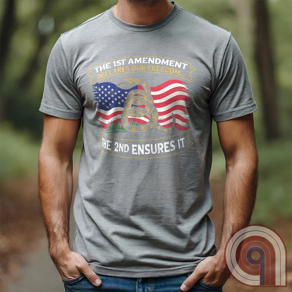 Stand for free speech and gun rights with this bold 1st & 2nd Amendment t-shirt. A distressed American flag with a coiled Gadsden snake, symbolizing freedom and resistance. ‘The 1st Amendment Declares Our Freedom… The 2nd Ensures It’ highlights the vital connection between free speech and the right to bear arms. A powerful design for gun rights advocates, patriots, and defenders of liberty who believe in self-defense, constitutional rights, and protecting American independence from tyranny. Color: Grey