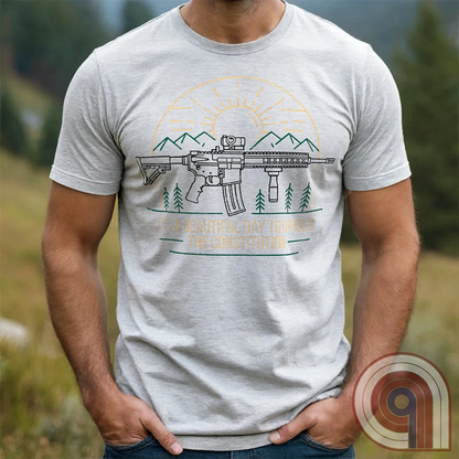 America was forged by the armed & unafraid. This ‘It’s a Beautiful Day to Uphold the Constitution’ t-shirt fuses the love of firearms with the untamed American spirit. Featuring an AR-15 set against rugged mountains and a blazing sunrise, this design screams independence, defiance, & unbreakable resolve. Whether you’re a hunter, soldier, or just a patriot who will not comply, this 2A shirt is a warning to tyrants: We don’t retreat. We reload. Wear it proudly and show that America will never bow; Color- Ash