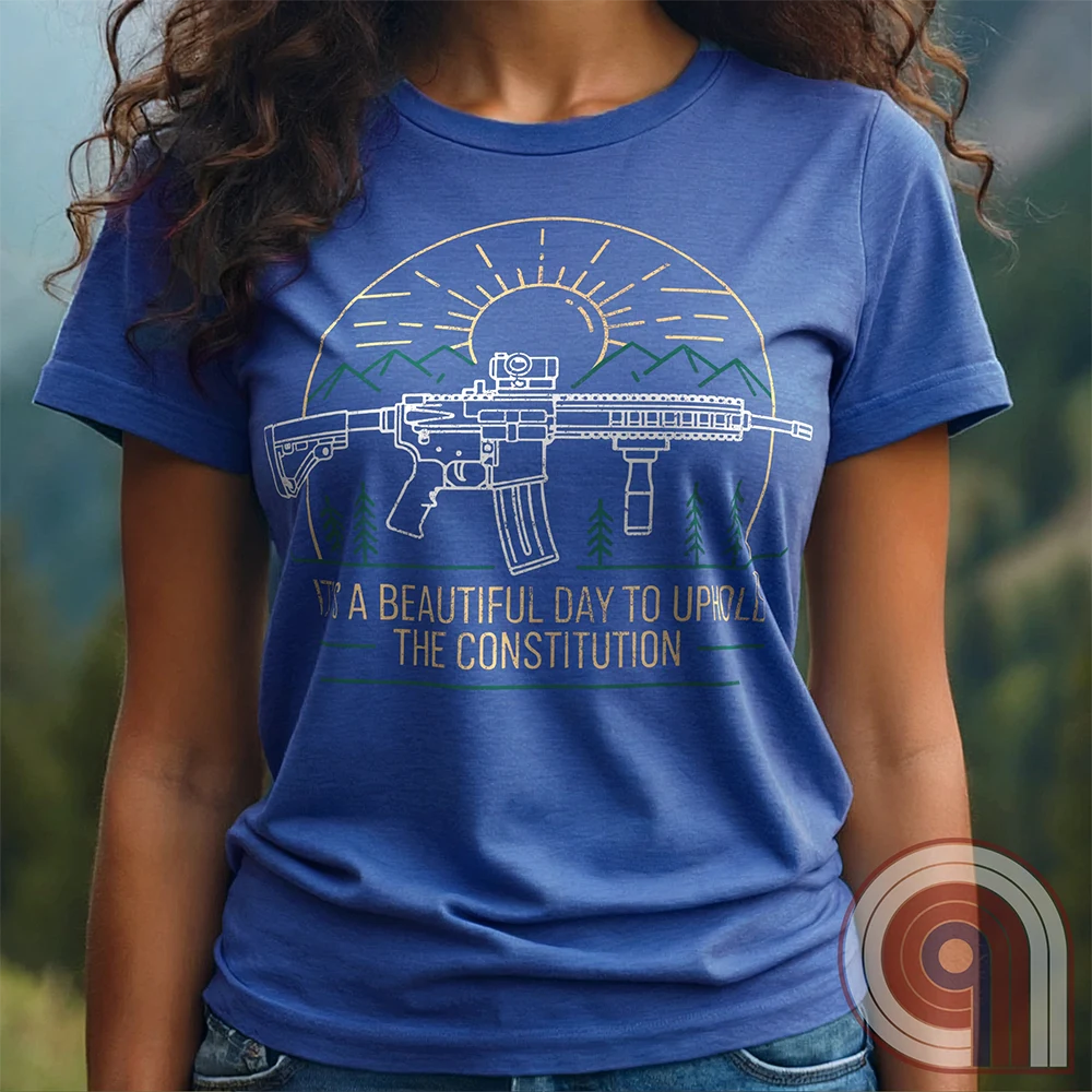 America was forged by the armed & unafraid. This ‘It’s a Beautiful Day to Uphold the Constitution’ t-shirt fuses the love of firearms with the untamed American spirit. Featuring an AR-15 set against rugged mountains and a blazing sunrise, this design screams independence, defiance, & unbreakable resolve. Whether you’re a hunter, soldier, or just a patriot who will not comply, this 2A shirt is a warning to tyrants: We don’t retreat. We reload. Wear it proudly and show that America will never bow; Color- Blue