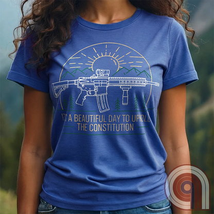 America was forged by the armed & unafraid. This ‘It’s a Beautiful Day to Uphold the Constitution’ t-shirt fuses the love of firearms with the untamed American spirit. Featuring an AR-15 set against rugged mountains and a blazing sunrise, this design screams independence, defiance, & unbreakable resolve. Whether you’re a hunter, soldier, or just a patriot who will not comply, this 2A shirt is a warning to tyrants: We don’t retreat. We reload. Wear it proudly and show that America will never bow; Color- Blue