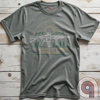 America was forged by the armed & unafraid. This ‘It’s a Beautiful Day to Uphold the Constitution’ t-shirt fuses the love of firearms with the untamed American spirit. Featuring an AR-15 set against rugged mountains and a blazing sunrise, this design screams independence, defiance, & unbreakable resolve. Whether you’re a hunter, soldier, or just a patriot who will not comply, this 2A shirt is a warning to tyrants: We don’t retreat. We reload. Wear it proudly and show that America will never bow; Color- Grey