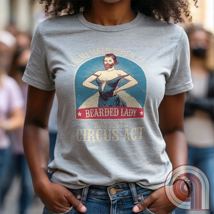 Step right up and witness the absurdity of modern times with this Bearded Lady Circus Act Freak Show Tee! Featuring a vintage sideshow design, this satirical shirt recalls an era when freak shows were confined to the circus tent—not celebrated in mainstream culture. Once a novelty act, now an everyday spectacle, this retro-inspired tee pokes fun at the bizarre shift in societal norms. Perfect for conservatives, free-thinkers, and those who refuse to accept forced narratives. Wear it loud! Color- Ash1