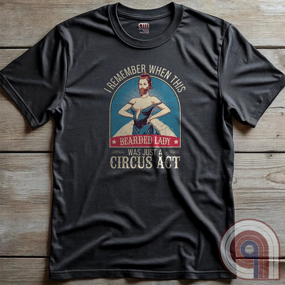 Step right up and witness the absurdity of modern times with this Bearded Lady Circus Act Freak Show Tee! Featuring a vintage sideshow design, this satirical shirt recalls an era when freak shows were confined to the circus tent—not celebrated in mainstream culture. Once a novelty act, now an everyday spectacle, this retro-inspired tee pokes fun at the bizarre shift in societal norms. Perfect for conservatives, free-thinkers, and those who refuse to accept forced narratives. Wear it loud! Color- Charc2