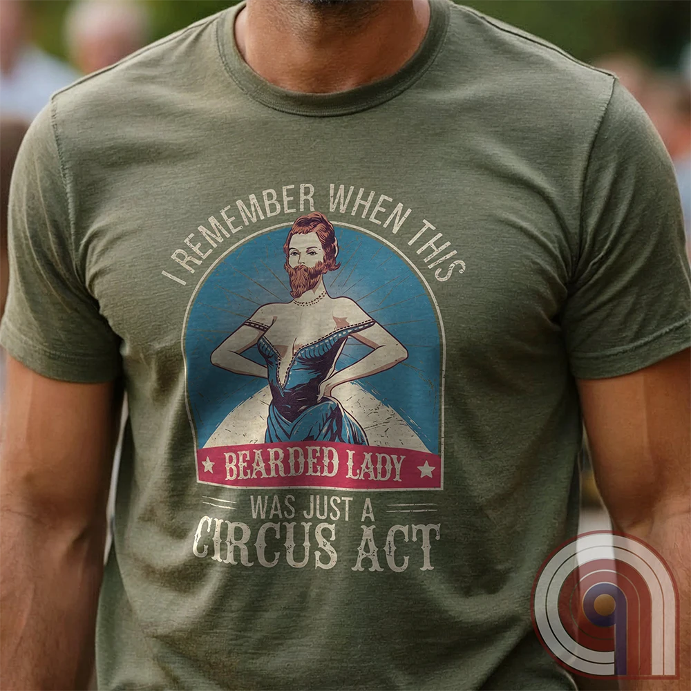 Step right up and witness the absurdity of modern times with this Bearded Lady Circus Act Freak Show Tee! Featuring a vintage sideshow design, this satirical shirt recalls an era when freak shows were confined to the circus tent—not celebrated in mainstream culture. Once a novelty act, now an everyday spectacle, this retro-inspired tee pokes fun at the bizarre shift in societal norms. Perfect for conservatives, free-thinkers, and those who refuse to accept forced narratives. Wear it loud! Color- Green1