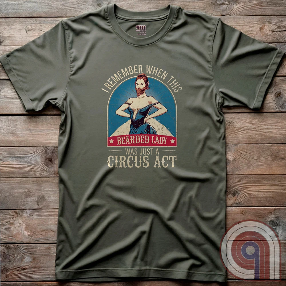 Step right up and witness the absurdity of modern times with this Bearded Lady Circus Act Freak Show Tee! Featuring a vintage sideshow design, this satirical shirt recalls an era when freak shows were confined to the circus tent—not celebrated in mainstream culture. Once a novelty act, now an everyday spectacle, this retro-inspired tee pokes fun at the bizarre shift in societal norms. Perfect for conservatives, free-thinkers, and those who refuse to accept forced narratives. Wear it loud! Color- Green2