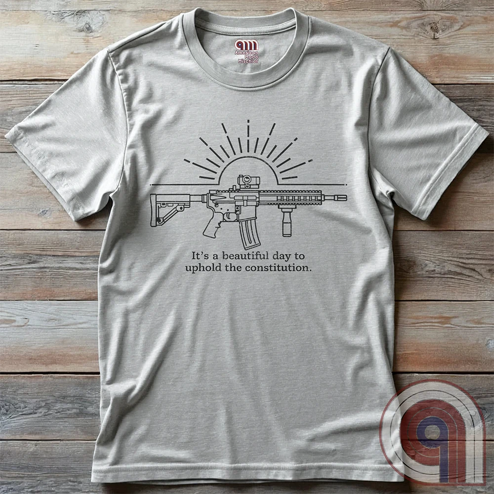 Freedom isn’t given, it’s defended. This ‘It’s a Beautiful Day to Uphold the Constitution’ t-shirt makes it clear—you’re armed, awake, & ready. Featuring an AR-15 against the rising sun, this pro-2A tee is for those who refuse to kneel to gun-grabbers, bureaucrats, or spineless politicians. Wear this bold firearm shirt as a warning: The 2nd Amendment isn’t up for debate. Patriots stand, cowards beg. Choose your side, make your statement, & remind the world why we will never surrender our rights; Color:Ash