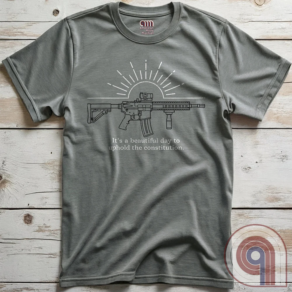 Freedom isn’t given, it’s defended. This ‘It’s a Beautiful Day to Uphold the Constitution’ t-shirt makes it clear—you’re armed, awake, & ready. Featuring an AR-15 against the rising sun, this pro-2A tee is for those who refuse to kneel to gun-grabbers, bureaucrats, or spineless politicians. Wear this bold firearm shirt as a warning: The 2nd Amendment isn’t up for debate. Patriots stand, cowards beg. Choose your side, make your statement, & remind the world why we will never surrender our rights;Color:Grey