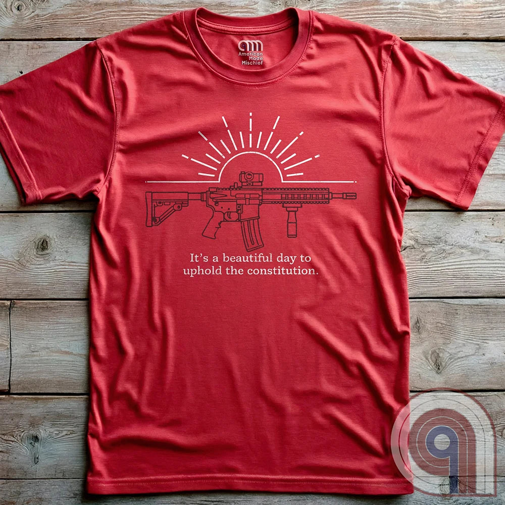 Freedom isn’t given, it’s defended. This ‘It’s a Beautiful Day to Uphold the Constitution’ t-shirt makes it clear—you’re armed, awake, & ready. Featuring an AR-15 against the rising sun, this pro-2A tee is for those who refuse to kneel to gun-grabbers, bureaucrats, or spineless politicians. Wear this bold firearm shirt as a warning: The 2nd Amendment isn’t up for debate. Patriots stand, cowards beg. Choose your side, make your statement, & remind the world why we will never surrender our rights;Color: Red
