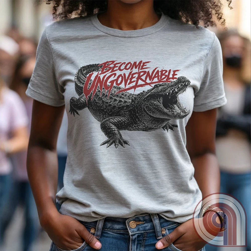 The modern world runs on control, structure, & compliance—but not everything is meant to be governed. This feral graphic tee channels raw instinct, reptilian awareness, &  refusal to be domesticated. Independence without permission, defiance without apology, & a mindset that doesn’t bend, break, or submit. For those who move differently, think independently, & operate outside imposed limits. Bold statement for fans of rebellion, freedom, primal instinct, & unapologetic self-governance. Ash on female model