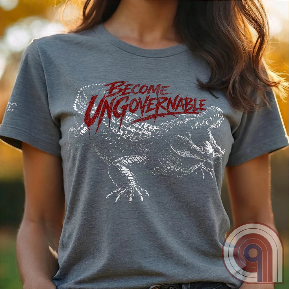 The modern world runs on control, structure, & compliance—but not everything is meant to be governed. This feral graphic tee channels raw instinct, reptilian awareness, &  refusal to be domesticated. Independence without permission, defiance without apology, & a mindset that doesn’t bend, break, or submit. For those who move differently, think independently, & operate outside imposed limits. Bold statement for fans of rebellion, freedom, primal instinct, & unapologetic self-governance. Grey on female model