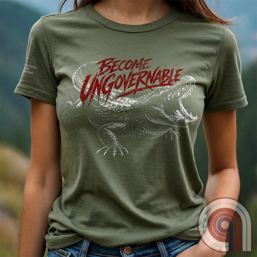 The modern world runs on control, structure, & compliance—but not everything is meant to be governed. This feral graphic tee channels raw instinct, reptilian awareness, &  refusal to be domesticated. Independence without permission, defiance without apology, & a mindset that doesn’t bend, break, or submit. For those who move differently, think independently, & operate outside imposed limits. Bold statement for fans of rebellion, freedom, primal instinct, & unapologetic self-governance. Green on female model