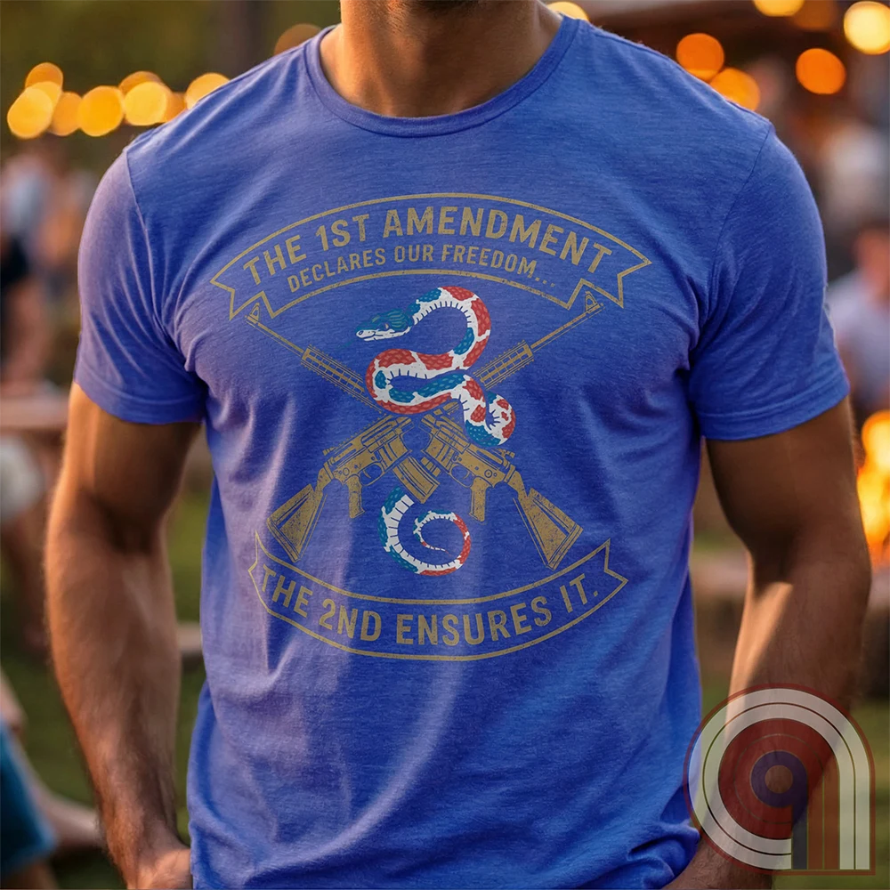 Show your commitment to the 1st & 2nd Amendments with this bold patriotic t-shirt. A fun 1A & 2A Tee featuring a red, white, & blue rattlesnake coiled around crossed rifles, this design represents free speech, gun rights, & resistance to tyranny. Perfect for Second Amendment supporters, constitutional patriots, & defenders of liberty. Whether you're standing against censorship or advocating for self-defense, this statement honors America’s founding principles and those who fight to protect them. Color: Blue