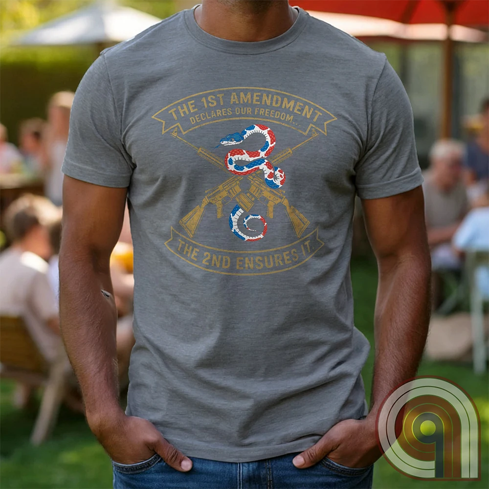 Show your commitment to the 1st & 2nd Amendments with this bold patriotic t-shirt. A fun 1A & 2A Tee featuring a red, white, & blue rattlesnake coiled around crossed rifles, this design represents free speech, gun rights, & resistance to tyranny. Perfect for Second Amendment supporters, constitutional patriots, & defenders of liberty. Whether you're standing against censorship or advocating for self-defense, this statement honors America’s founding principles and those who fight to protect them. Color: Grey
