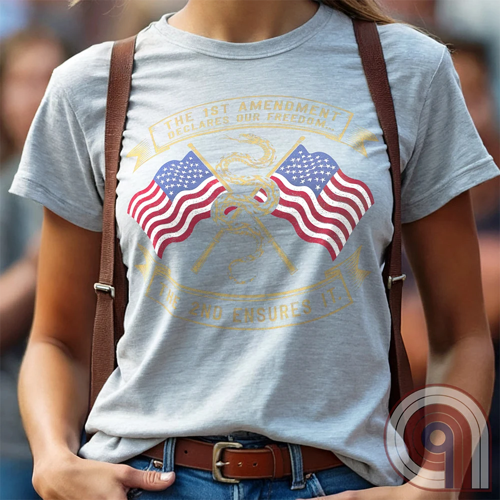 Declare your commitment to freedom & constitutional rights with this bold 1st & 2nd Amendment t-shirt. Featuring a Gadsden snake wrapped around crossed rifles with American flags symbolizing the fight for free speech & the right to bear arms. For Second Amendment supporters, liberty lovers, & patriots who stand against tyranny, censorship, & government overreach. Show your support for self-defense, independence, & American values with this powerful statement of resistance & American pride. Color: Ash