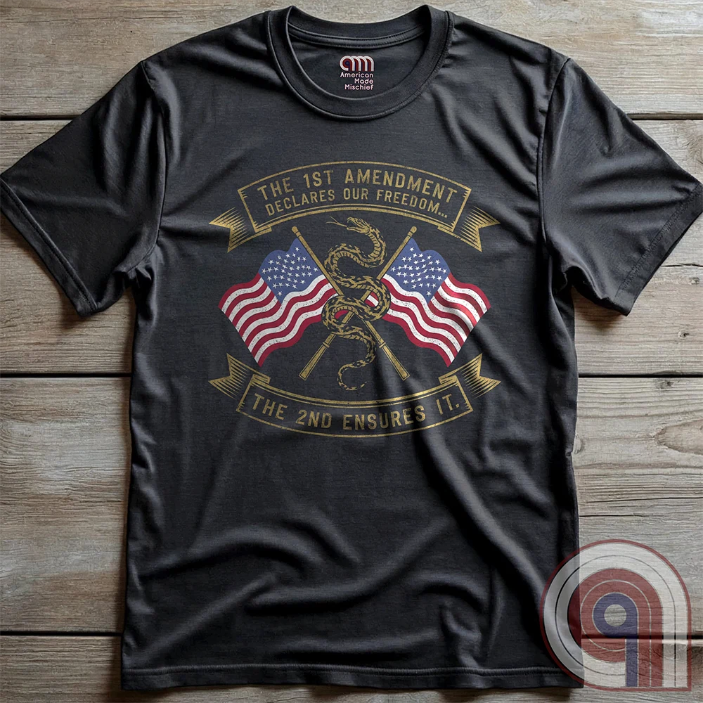 Declare your commitment to freedom & constitutional rights with this bold 1st & 2nd Amendment t-shirt. Featuring a Gadsden snake wrapped around crossed rifles with American flags symbolizing the fight for free speech & the right to bear arms. For Second Amendment supporters, liberty lovers, & patriots who stand against tyranny, censorship, & government overreach. Show your support for self-defense, independence, & American values with this powerful statement of resistance & American pride. Color: Charc