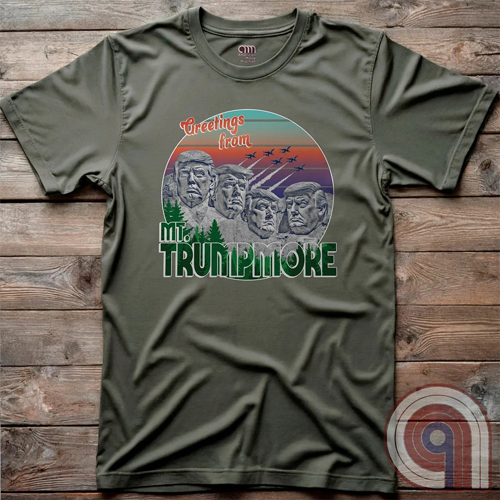 Celebrate American greatness with the "Greetings from Mt. Trumpmore" T-shirt, a bold patriotic parody of Mount Rushmore featuring Donald Trump’s face carved in stone. A retro-style souvenir tee perfect for MAGA supporters, conservatives, & those who see Trump as one of America’s greatest presidents. With vintage postcard aesthetics, fighter jets soaring in the sunset, & a nod to national pride, this Trump tribute shirt is a must-have for patriots who refuse to apologize for loving the USA. Color - Green2