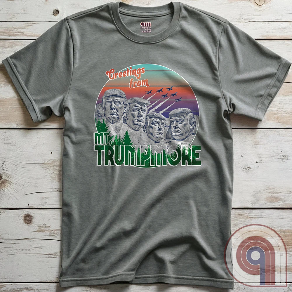 Celebrate American greatness with the "Greetings from Mt. Trumpmore" T-shirt, a bold patriotic parody of Mount Rushmore featuring Donald Trump’s face carved in stone. A retro-style souvenir tee perfect for MAGA supporters, conservatives, & those who see Trump as one of America’s greatest presidents. With vintage postcard aesthetics, fighter jets soaring in the sunset, & a nod to national pride, this Trump tribute shirt is a must-have for patriots who refuse to apologize for loving the USA. Color - Grey2