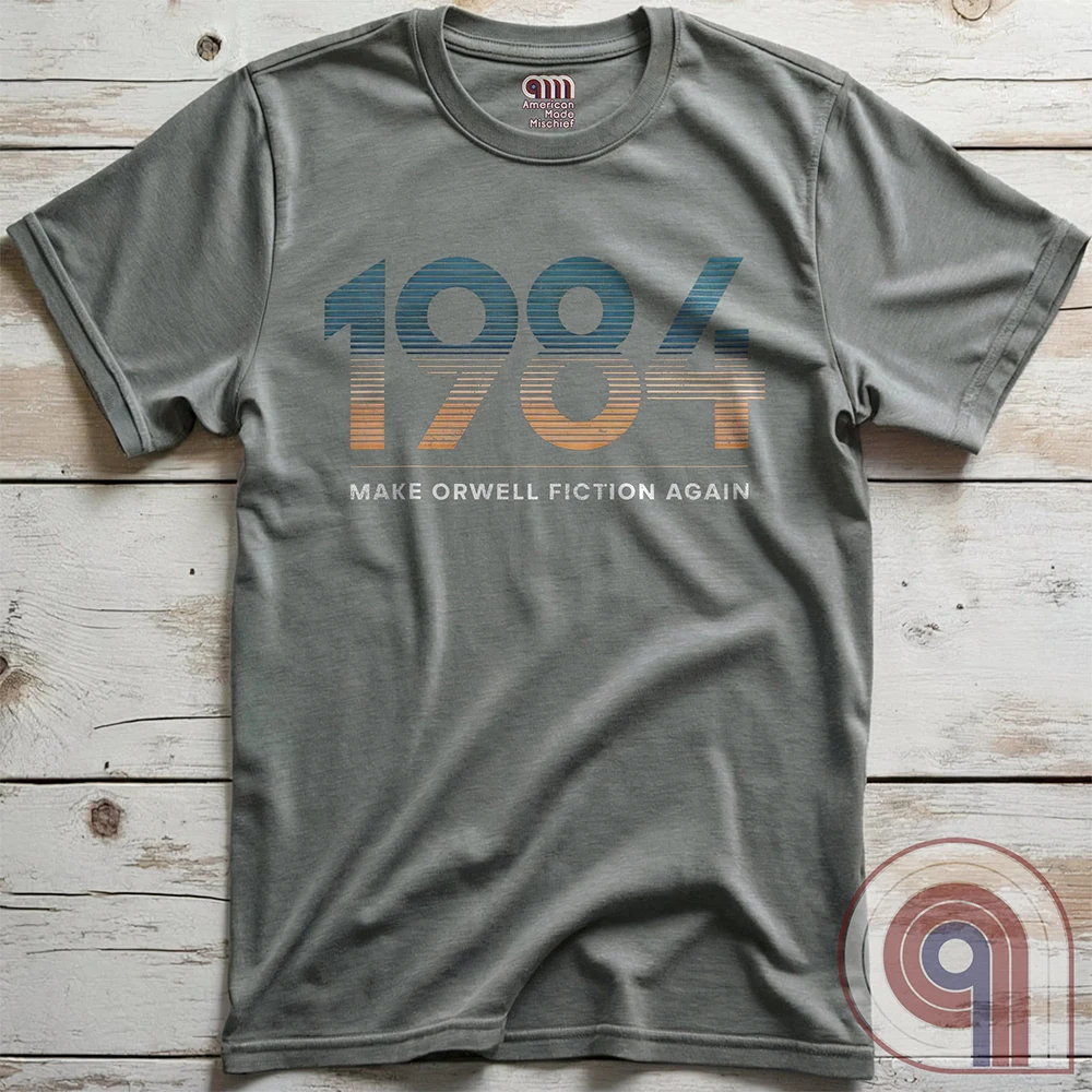 Censorship spreads like wildfire. This ‘Make Orwell Fiction Again’ t-shirt is for those who see past the lies and refuse to bow to the thought police. Featuring a powerful retro design, this shirt is a battle cry for free thinkers and speech warriors who defy controlled narratives. Because words are weapons and history is rewritten daily, this tee is the uniform of the resistance. Wear it and remind them that silence is complicity. The war on reality is waged in every headline and algorithm. Color: Grey