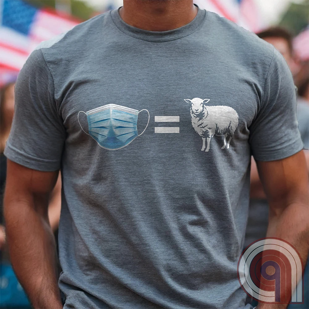 Heather grey T-shirt worn by a model, displaying a blue surgical-style mask, white equals sign and white sheep in a spare visual equation satirizing conformity around mask wearing.
