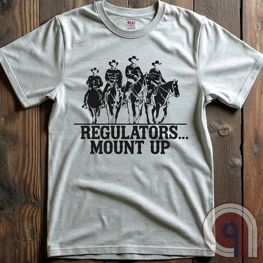Ride high with the 'Regulators... Mount Up' t-shirt, a fearless call to action for patriots who stand for unity, resilience, & the preservation of American values. Inspired by frontier justice, this Western tee embodies the spirit of Texas Rangers, Border Patrol Agents, & Minute-Men. A tribute to law & order, standing strong, & defending freedom, it's perfect for those who believe in 2A, 1A, & American spirit. Whether you're a cowboy, prepper, or patriot, wear it with pride and ride for liberty. Ash