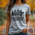 Ride high with the 'Regulators... Mount Up' t-shirt, a fearless call to action for patriots who stand for unity, resilience, & the preservation of American values. Inspired by frontier justice, this Western tee embodies the spirit of Texas Rangers, Border Patrol Agents, & Minute-Men. A tribute to law & order, standing strong, & defending freedom, it's perfect for those who believe in 2A, 1A, & American spirit. Whether you're a cowboy, prepper, or patriot, wear it with pride and ride for liberty. Ash