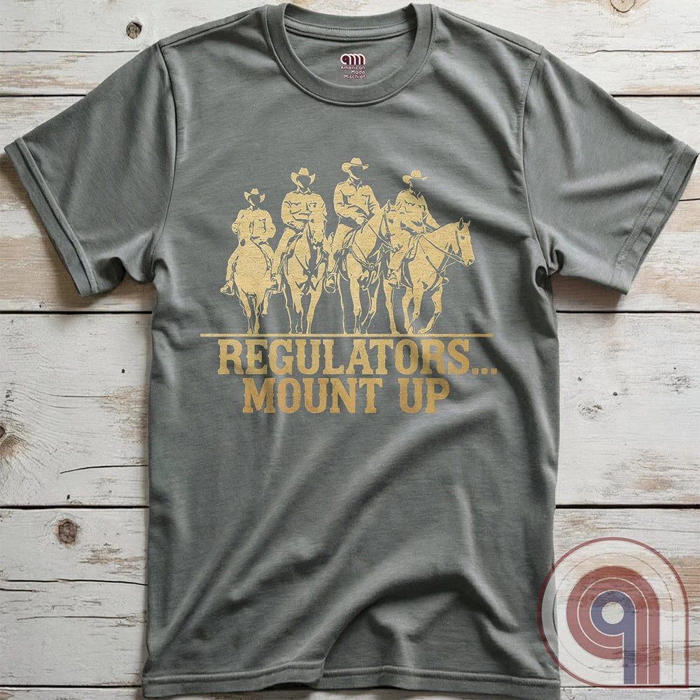 Ride high with the 'Regulators... Mount Up' t-shirt, a fearless call to action for patriots who stand for unity, resilience, & the preservation of American values. Inspired by frontier justice, this Western tee embodies the spirit of Texas Rangers, Border Patrol Agents, & Minute-Men. A tribute to law & order, standing strong, & defending freedom, it's perfect for those who believe in 2A, 1A, & American spirit. Whether you're a cowboy, prepper, or patriot, wear it with pride and ride for liberty. Grey