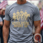 Ride high with the 'Regulators... Mount Up' t-shirt, a fearless call to action for patriots who stand for unity, resilience, & the preservation of American values. Inspired by frontier justice, this Western tee embodies the spirit of Texas Rangers, Border Patrol Agents, & Minute-Men. A tribute to law & order, standing strong, & defending freedom, it's perfect for those who believe in 2A, 1A, & American spirit. Whether you're a cowboy, prepper, or patriot, wear it with pride and ride for liberty. Grey