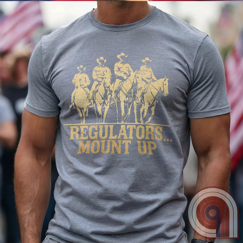 Ride high with the 'Regulators... Mount Up' t-shirt, a fearless call to action for patriots who stand for unity, resilience, & the preservation of American values. Inspired by frontier justice, this Western tee embodies the spirit of Texas Rangers, Border Patrol Agents, & Minute-Men. A tribute to law & order, standing strong, & defending freedom, it's perfect for those who believe in 2A, 1A, & American spirit. Whether you're a cowboy, prepper, or patriot, wear it with pride and ride for liberty. Grey