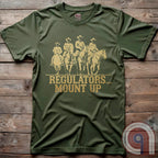 Ride high with the 'Regulators... Mount Up' t-shirt, a fearless call to action for patriots who stand for unity, resilience, & the preservation of American values. Inspired by frontier justice, this Western tee embodies the spirit of Texas Rangers, Border Patrol Agents, & Minute-Men. A tribute to law & order, standing strong, & defending freedom, it's perfect for those who believe in 2A, 1A, & American spirit. Whether you're a cowboy, prepper, or patriot, wear it with pride and ride for liberty. Green