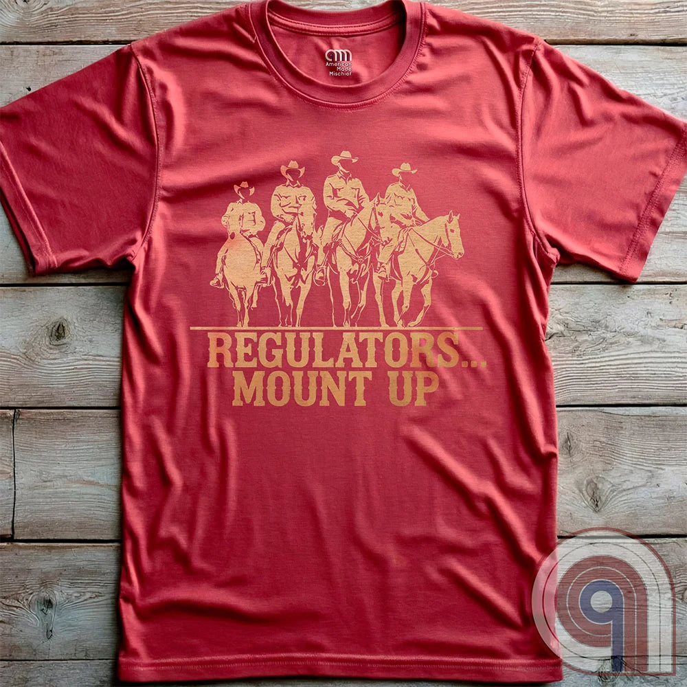 Ride high with the 'Regulators... Mount Up' t-shirt, a fearless call to action for patriots who stand for unity, resilience, & the preservation of American values. Inspired by frontier justice, this Western tee embodies the spirit of Texas Rangers, Border Patrol Agents, & Minute-Men. A tribute to law & order, standing strong, & defending freedom, it's perfect for those who believe in 2A, 1A, & American spirit. Whether you're a cowboy, prepper, or patriot, wear it with pride and ride for liberty. Red
