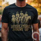 Ride high with the 'Regulators... Mount Up' t-shirt, a fearless call to action for patriots who stand for unity, resilience, & the preservation of American values. Inspired by frontier justice, this Western tee embodies the spirit of Texas Rangers, Border Patrol Agents, & Minute-Men. A tribute to law & order, standing strong, & defending freedom, it's perfect for those who believe in 2A, 1A, & American spirit. Whether you're a cowboy, prepper, or patriot, wear it with pride and ride for liberty. Charcoal