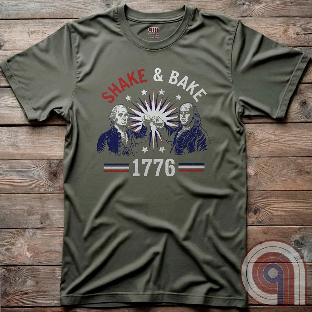 Revolution meets the racetrack with this Talladega Nights-inspired “Shake & Bake 1776” design, featuring George Washington and Benjamin Franklin throwing a victorious fist bump. A patriotic mashup of NASCAR culture and Founding Father grit, this tee celebrates American independence with speed, style, and historical swagger. Perfect for history buffs, liberty lovers, and anyone who believes in freedom, fast cars, and finishing first—because if you ain’t first, you’re last! Comedy Parody Tee. Color- Green