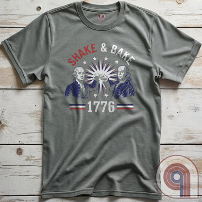 Revolution meets the racetrack with this Talladega Nights-inspired “Shake & Bake 1776” design, featuring George Washington and Benjamin Franklin throwing a victorious fist bump. A patriotic mashup of NASCAR culture and Founding Father grit, this tee celebrates American independence with speed, style, and historical swagger. Perfect for history buffs, liberty lovers, and anyone who believes in freedom, fast cars, and finishing first—because if you ain’t first, you’re last! Comedy Parody Tee. Color-Grey