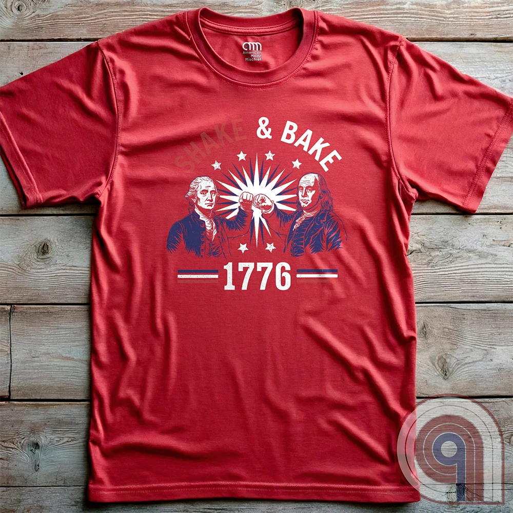 Revolution meets the racetrack with this Talladega Nights-inspired “Shake & Bake 1776” design, featuring George Washington and Benjamin Franklin throwing a victorious fist bump. A patriotic mashup of NASCAR culture and Founding Father grit, this tee celebrates American independence with speed, style, and historical swagger. Perfect for history buffs, liberty lovers, and anyone who believes in freedom, fast cars, and finishing first—because if you ain’t first, you’re last! Comedy Parody Tee. Color-Red
