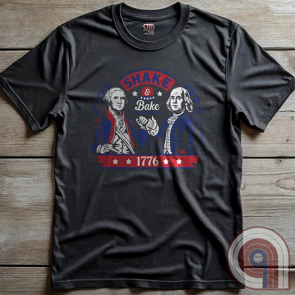Shake & Bake 1776 t-shirt - George Washington and Thomas Jefferson pulling off a legendary Talladega Nights-style fist bump. Inspired by the Ricky Bobby & Cal Naughton Jr. duo, this design blends NASCAR culture with American Revolution history for a high-octane dose of freedom, fast cars, & Founding Fathers. For patriots, history buffs, & fans of red, white, & blue mischief, this tee is a must-have for those who live life in the fast lane and embrace American independence with a comedic twist. Color- Charc