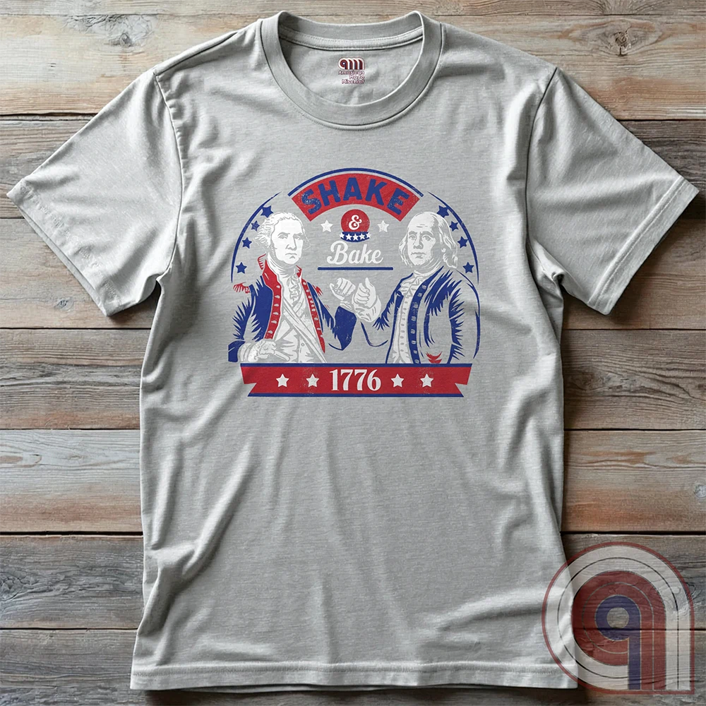 Shake & Bake 1776 t-shirt - George Washington and Thomas Jefferson pulling off a legendary Talladega Nights-style fist bump. Inspired by the Ricky Bobby & Cal Naughton Jr. duo, this design blends NASCAR culture with American Revolution history for a high-octane dose of freedom, fast cars, & Founding Fathers. For patriots, history buffs, & fans of red, white, & blue mischief, this tee is a must-have for those who live life in the fast lane and embrace American independence with a comedic twist. Color- Ash