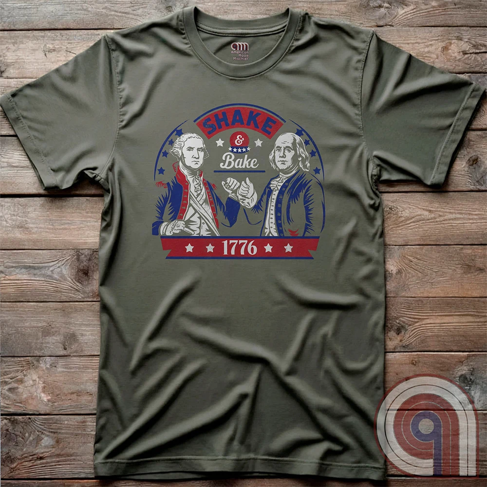 Shake & Bake 1776 t-shirt - George Washington and Thomas Jefferson pulling off a legendary Talladega Nights-style fist bump. Inspired by the Ricky Bobby & Cal Naughton Jr. duo, this design blends NASCAR culture with American Revolution history for a high-octane dose of freedom, fast cars, & Founding Fathers. For patriots, history buffs, & fans of red, white, & blue mischief, this tee is a must-have for those who live life in the fast lane and embrace American independence with a comedic twist. Color- Green