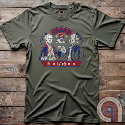 Shake & Bake 1776 t-shirt - George Washington and Thomas Jefferson pulling off a legendary Talladega Nights-style fist bump. Inspired by the Ricky Bobby & Cal Naughton Jr. duo, this design blends NASCAR culture with American Revolution history for a high-octane dose of freedom, fast cars, & Founding Fathers. For patriots, history buffs, & fans of red, white, & blue mischief, this tee is a must-have for those who live life in the fast lane and embrace American independence with a comedic twist. Color- Green