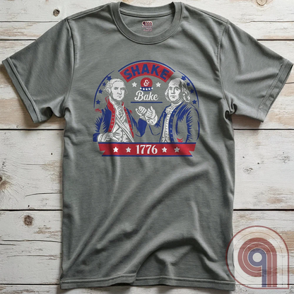 Shake & Bake 1776 t-shirt - George Washington and Thomas Jefferson pulling off a legendary Talladega Nights-style fist bump. Inspired by the Ricky Bobby & Cal Naughton Jr. duo, this design blends NASCAR culture with American Revolution history for a high-octane dose of freedom, fast cars, & Founding Fathers. For patriots, history buffs, & fans of red, white, & blue mischief, this tee is a must-have for those who live life in the fast lane and embrace American independence with a comedic twist. Color-Grey