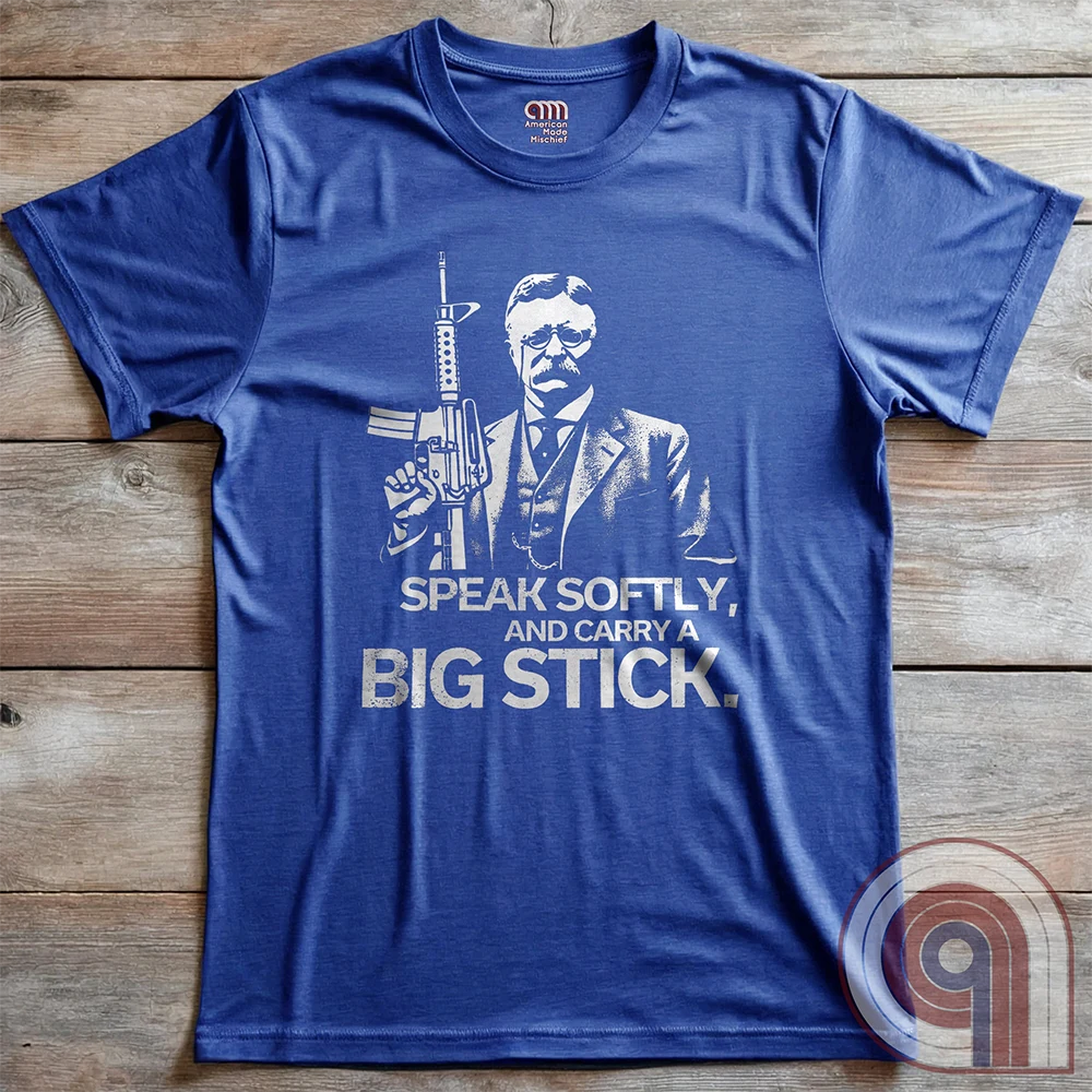 Striking Teddy Roosevelt 2A T-Shirt - legendary Rough Rider and American icon, with an AR-15 and his, 'Speak Softly, and Carry a Big Stick.' This design is a fearless blend of patriotism, rugged individuality, & Second Amendment rights. Perfect for gun lovers, history buffs, & freedom fighters who embrace bold American values. Pro-Second Amendment clothing that makes a statement—real leaders don’t ask permission to defend liberty. A tribute to freedom, strength, and the right to bear arms. Color- Blue2