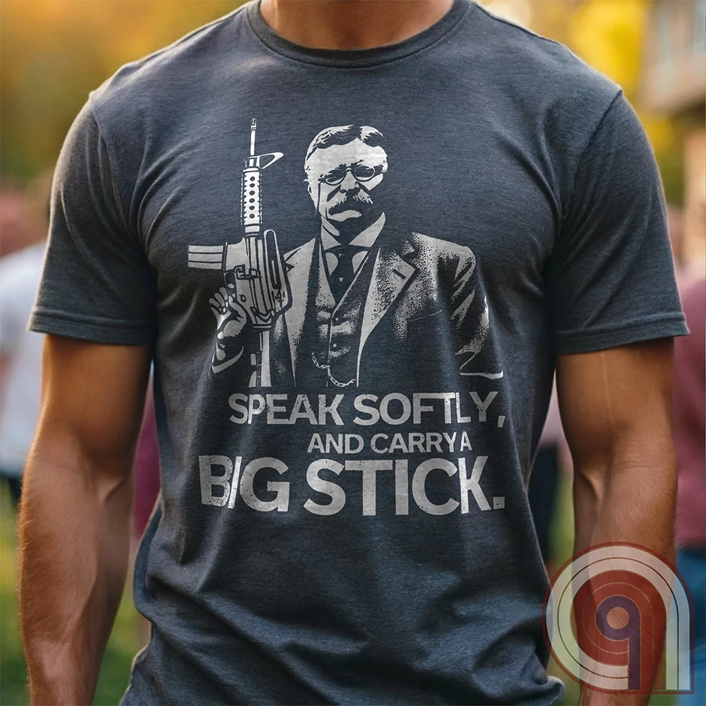 Striking Teddy Roosevelt 2A T-Shirt - legendary Rough Rider and American icon, with an AR-15 and his, 'Speak Softly, and Carry a Big Stick.' This design is a fearless blend of patriotism, rugged individuality, & Second Amendment rights. Perfect for gun lovers, history buffs, & freedom fighters who embrace bold American values. Pro-Second Amendment clothing that makes a statement—real leaders don’t ask permission to defend liberty. A tribute to freedom, strength, and the right to bear arms. Color- Charc1