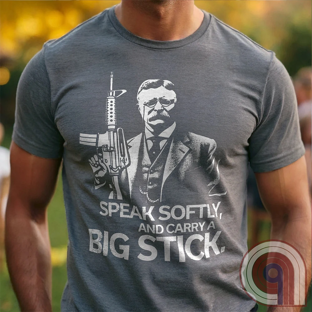 Striking Teddy Roosevelt 2A T-Shirt - legendary Rough Rider and American icon, with an AR-15 and his, 'Speak Softly, and Carry a Big Stick.' This design is a fearless blend of patriotism, rugged individuality, & Second Amendment rights. Perfect for gun lovers, history buffs, & freedom fighters who embrace bold American values. Pro-Second Amendment clothing that makes a statement—real leaders don’t ask permission to defend liberty. A tribute to freedom, strength, and the right to bear arms. Color- Grey1