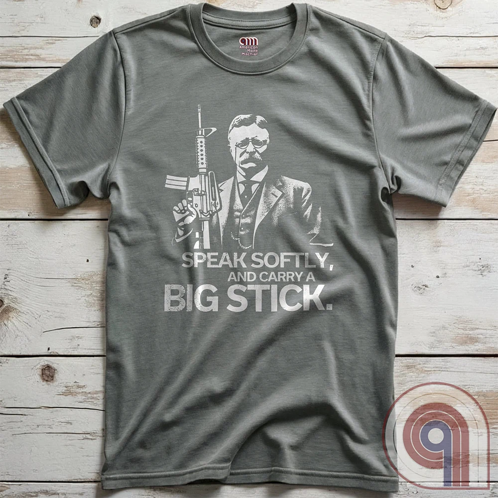 Striking Teddy Roosevelt 2A T-Shirt - legendary Rough Rider and American icon, with an AR-15 and his, 'Speak Softly, and Carry a Big Stick.' This design is a fearless blend of patriotism, rugged individuality, & Second Amendment rights. Perfect for gun lovers, history buffs, & freedom fighters who embrace bold American values. Pro-Second Amendment clothing that makes a statement—real leaders don’t ask permission to defend liberty. A tribute to freedom, strength, and the right to bear arms. Color- Grey2