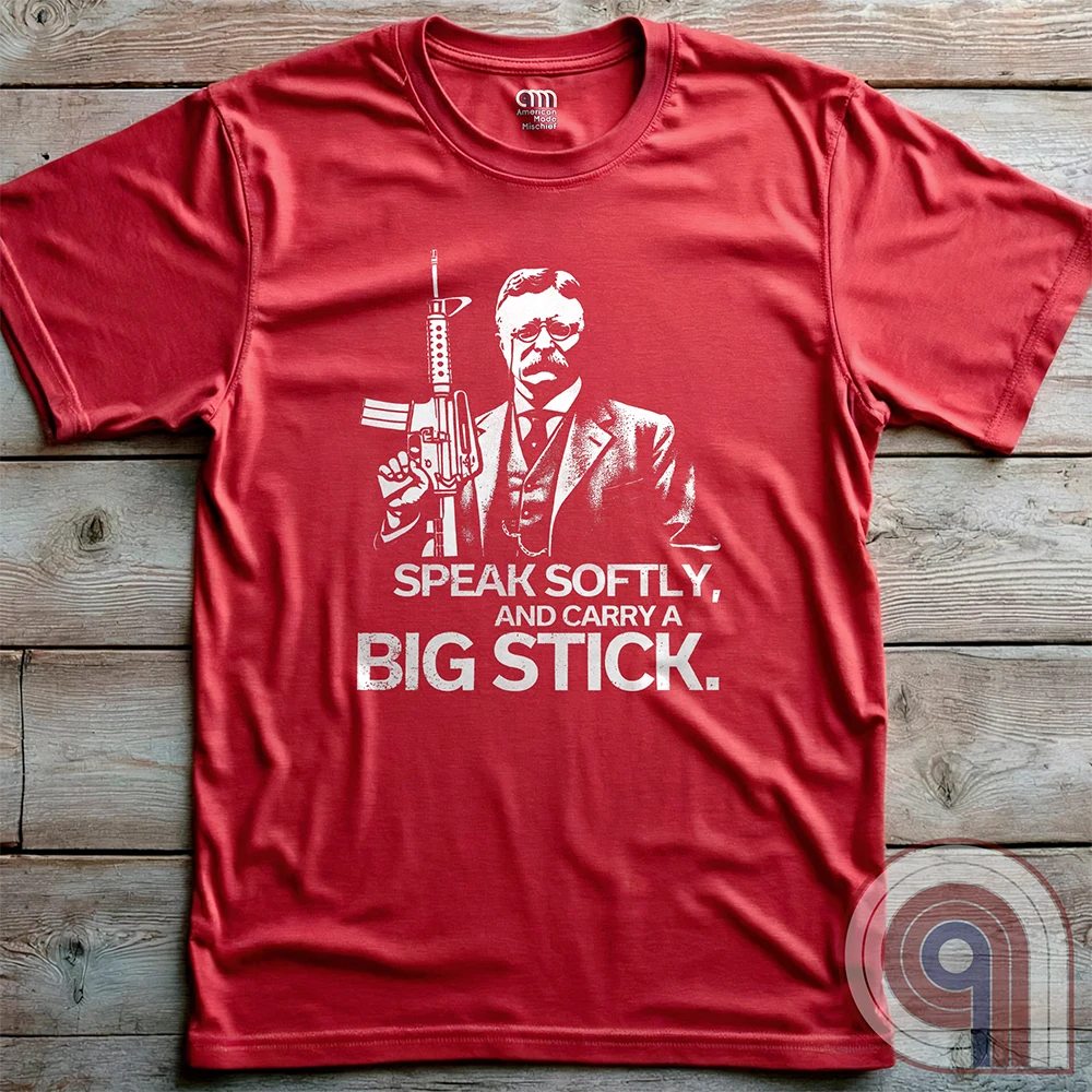 Striking Teddy Roosevelt 2A T-Shirt - legendary Rough Rider and American icon, with an AR-15 and his, 'Speak Softly, and Carry a Big Stick.' This design is a fearless blend of patriotism, rugged individuality, & Second Amendment rights. Perfect for gun lovers, history buffs, & freedom fighters who embrace bold American values. Pro-Second Amendment clothing that makes a statement—real leaders don’t ask permission to defend liberty. A tribute to freedom, strength, and the right to bear arms. Color- Red2